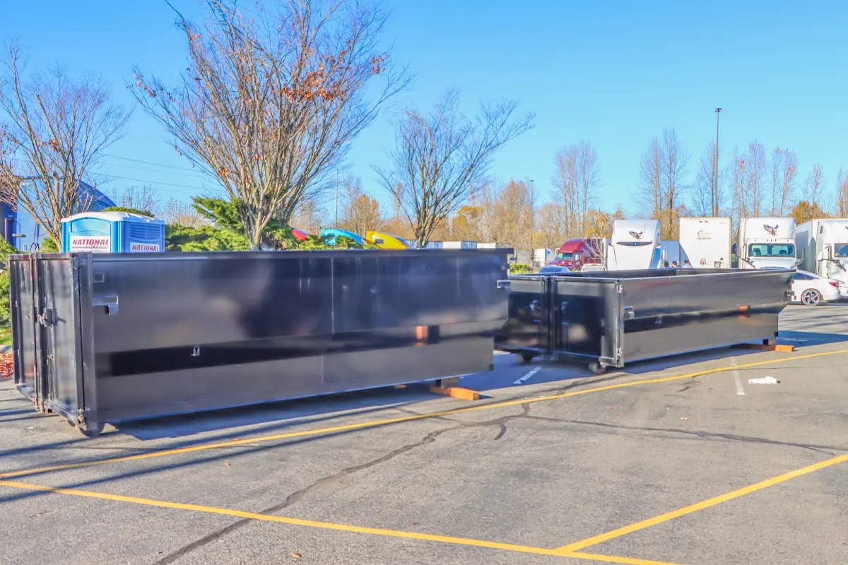 Professional dumpster rental service with roll-off container on residential driveway in Wesley Hills